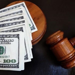 Judge gavel and money on black background - Dubyak Law Firm, P.A