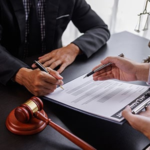 Lawyer signing a contract with a client regarding quiet title actions in Florida